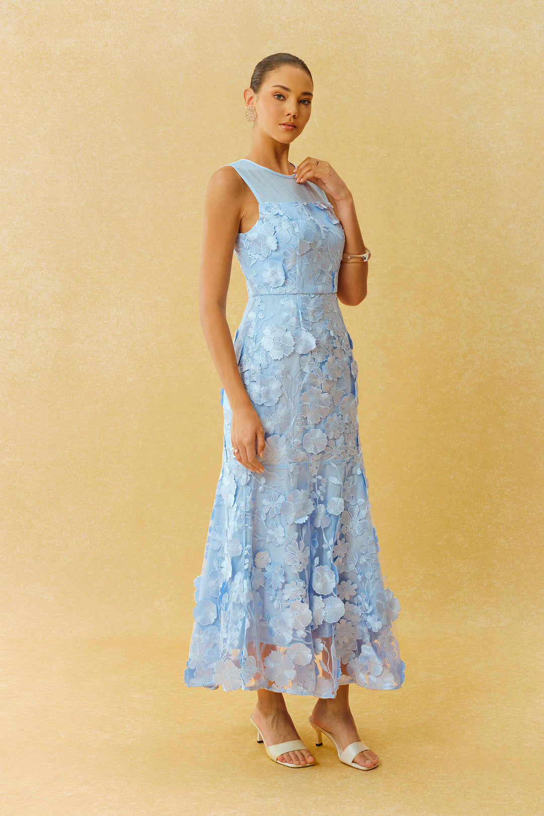 Nahaufnahme des Stoffs und der Blumenapplikation auf dem Kleid - KYMA